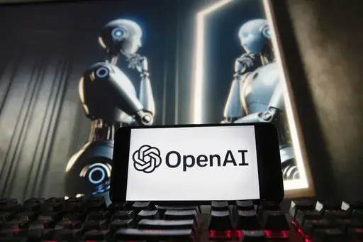 The OpenAI logo is seen displayed on a cell phone with an image on a computer monitor generated by ChatGPT's Dall-E text-to-image model, Friday, Dec. 8, 2023, in Boston. A former OpenAI leader who resigned from the company earlier this week said on Friday that product safety has "taken a backseat to shiny products" at the influential artificial intelligence company. (AP Photo/Michael Dwyer, file)