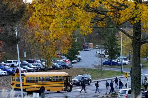 High School students return to school for the first time since the shootings that claimed 18 lives in their community, Tuesday, Oct. 31, 2023, in Lewiston, Maine. (AP Photo/Matt York)