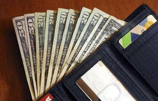 Cash is fanned out from a wallet in North Andover, Mass., June 15, 2018. The U.S. economy grew faster than expected in the July-September 2022 quarter, the government reported Thursday, Oct. 27, 2022, underscoring that the United States is not in a recession despite distressingly high inflation and interest rate hikes by the Federal Reserve. But the economy is hardly in the clear. (AP Photo/Elise Amendola, File)