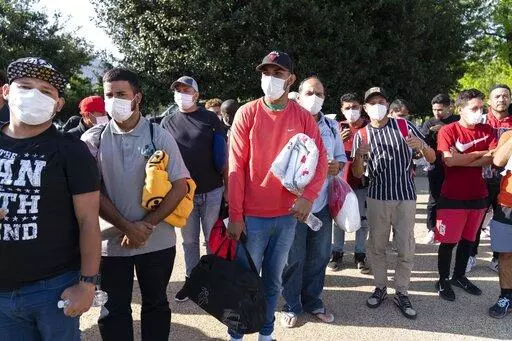 Migrants hold Red Cross blankets after arriving at Union Station near the U.S. Capitol from Texas on buses, April 27, 2022, in Washington.  The Pentagon has rejected a request from the District of Columbia seeking National Guard assistance for the thousands of migrants being bused to the city from two southern states. (AP Photo/Jose Luis Magana, File)