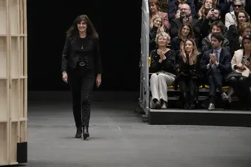 Designer Virginie Viard accepts applause at the end of the Chanel Haute Couture Spring-Summer 2023 collection presented in Paris, on Jan. 24, 2023. Virginie Viard, the artistic director of Chanel who replaced Karl Lagerfeld after his death, has left, the French fashion house said on Thursday. Chanel did not immediately announce a replacement for the the 62-year-old Viard, who worked with Lagerfeld for more than two decades. (AP Photo/Christophe Ena, File)