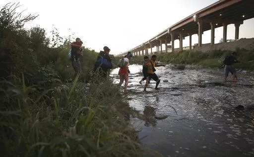 Venezuelan migrants walk across the Rio Bravo towards the United States border to surrender to the border patrol, from Ciudad Juarez, Mexico, Oct. 13, 2022. A surge in migration from Venezuela, Cuba and Nicaragua in September brought the number of illegal crossings to the highest level ever recorded in a fiscal year, according to U.S. Customs and Border Protection. (AP Photo/Christian Chavez, File)