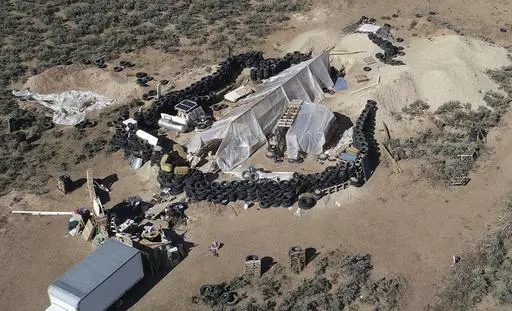 A ramshackle compound is seen in the desert area of Amalia, N.M., on Aug. 10, 2018. A U.S. judge is expected to hand down sentences Wednesday, March 6, 2024, for five defendants in a federal terrorism and kidnapping case that stemmed from the search for a toddler who went missing from Georgia in late 2017 that ended months later with a raid on the squalid compound in northern New Mexico. (AP Photo/Brian Skoloff, File)
