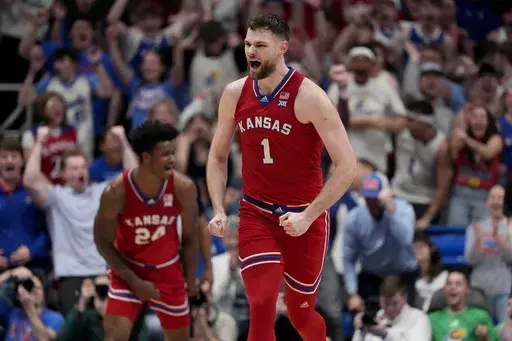 Kansas center Hunter Dickinson (1) celebrates after making a basket during the second half of an NCAA college basketball game against Arizona Saturday, March 8, 2025, in Lawrence, Kan. (AP Photo/Charlie Riedel)