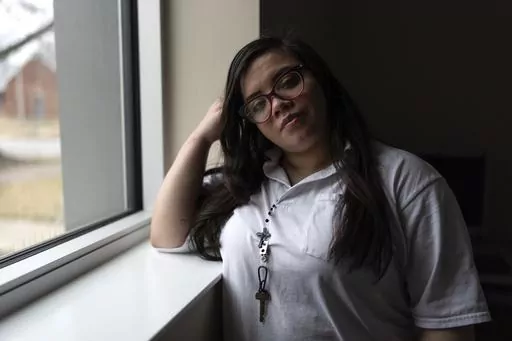 31-year-old Crystal Martinez stands for a portrait after speaking about her experiences with domestic violence and life in prison without her children Friday, Jan. 26, 2024, at Logan Correctional Center in Lincoln, Ill. Martinez's eight-year sentence for shooting a man she said was beating his girlfriend at the time was recently reduced under an Illinois law that allows survivors of domestic violence to ask for shorter sentences. (AP Photo/Erin Hooley)