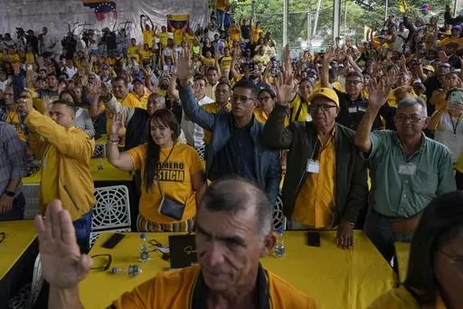 Supporters of opposition leader and former presidential candidate Henrique Capriles raise their hands as they take an oath to support him as the presidential candidate for the Primero Justicia party ahead of the opposition primary in Caracas, Venezuela, Friday, March 10, 2023. Opposition parties for years encouraged voters to boycott elections before urging them to participate in the planned October 2023 primary election to chose a single candidate to face current President Nicolas Maduro at the