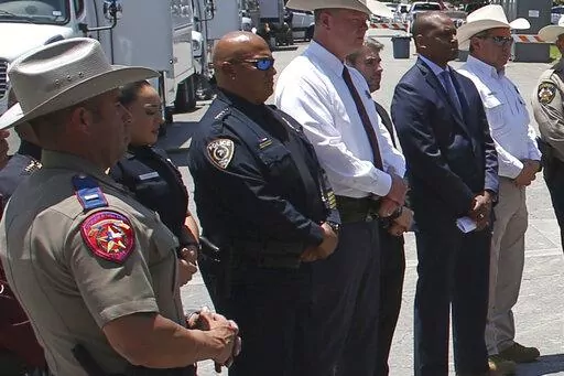 Uvalde School Police Chief Pete Arredondo, third from left, stands during a news conference outside of the Robb Elementary school in Uvalde, Texas Thursday, May 26, 2022.  The district’s superintendent said Wednesday, June 22 that Arredondo has been put on leave following allegations that he erred in his response to a mass shooting at an elementary school that left 19 students and two teachers dead.  (AP Photo/Dario Lopez-Mills, File)