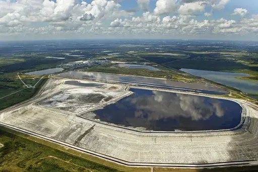 A sinkhole that opened up underneath a gypsum stack at a Mosaic phosphate fertilizer plant is seen in Mulberry, Fla., on Sept. 16, 2016. (Jim Damaske/Tampa Bay Times via AP, File)