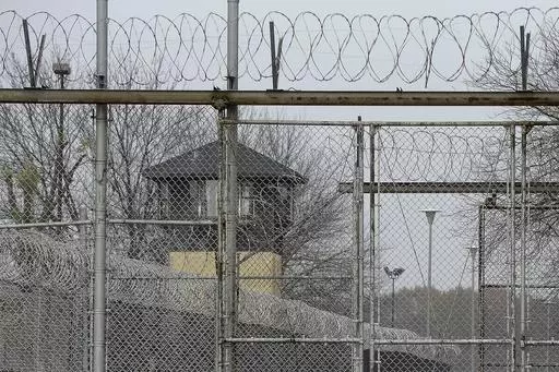 Security fences surround the Illinois Department of Corrections' Logan Correctional Center, Nov. 18, 2016, in Lincoln, Ill. Illinois Gov. J.B. Pritzker's administration has retained a contentious choice for providing medical care to prison inmates, awarding Wexford Health Sources a 10-year, $4.16 billion contract despite high vacancy rates, complaints of substandard care and lawmakers' agitation to find a replacement. (AP Photo/Seth Perlman, File)