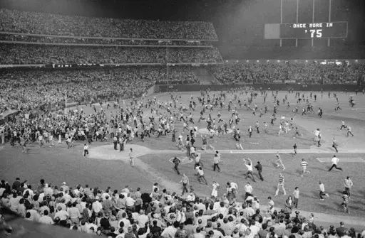 Fans pour onto the field at the Oakland Coliseum after the Oakland A's beat the Los Angeles Dodgers 3-2 and won their third straight World Series, Oct. 17, 1974, in Oakland. (AP Photo, File)