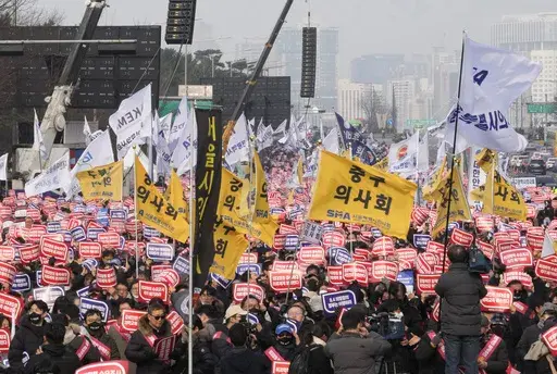Doctors stage a rally against the government's medical policy in Seoul, South Korea, Sunday, March 3, 2024. Thousands of senior doctors rallied in Seoul on Sunday to express their support for junior doctors who have been on strike for nearly two weeks over a government plan to sharply increase the number of medical school admissions.(AP Photo/Ahn Young-joon)