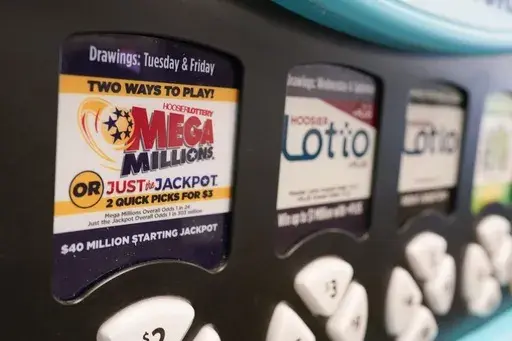 A Mega Millions logo is displayed on a vending machine at the Hoosier Lottery booth at the Indiana State Fair, Aug. 3, 2023, in Indianapolis. (AP Photo/Darron Cummings, File)