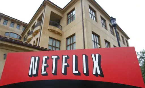 This photo shows the company logo and view of Netflix headquarters in Los Gatos, Calif., Jan. 29, 2010. Netflix shed almost 1 million subscribers during the spring amid tougher competition and soaring inflation that’s squeezing household budgets, heightening the urgency behind the video streaming service’s effort to launch a cheaper option with commercial interruptions. The April-June contraction of 970,000 accounts, announced Tuesday, July 19, 2022, as part of Netflix’s second-quarter ear