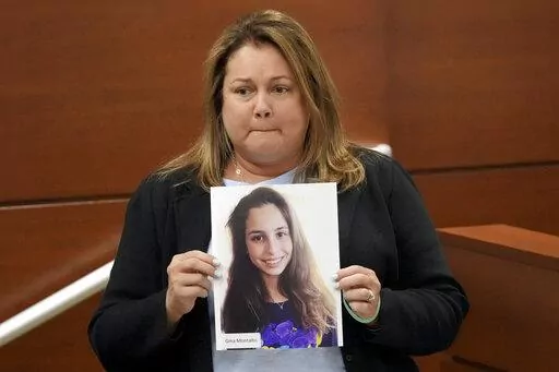 Jennifer Montalto holds a picture of her daughter, Gina, before giving her victim impact statement during the penalty phase of the trial of Marjory Stoneman Douglas High School shooter Nikolas Cruz at the Broward County Courthouse in Fort Lauderdale, Fla., Wednesday, Aug. 3, 2022. Gina Montalto was killed in the 2018 shootings. Cruz previously plead guilty to all 17 counts of premeditated murder and 17 counts of attempted murder in the 2018 shootings. (Amy Beth Bennett/South Florida Sun Sentinel