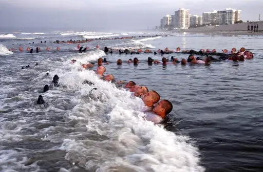 U.S. Navy SEAL candidates, participate in "surf immersion" during Basic Underwater Demolition/SEAL (BUD/S) training at the Naval Special Warfare (NSW) Center in Coronado, Calif., on May 4, 2020. A Navy SEAL candidate who died just hours after completing the grueling Hell Week test was identified Sunday, Feb. 6, 2022, as a 24-year-old sailor who joined the military last year. The U.S. Navy said that Seaman Kyle Mullen died at a San Diego area hospital on Friday, Feb. 4, after he and another SEAL 