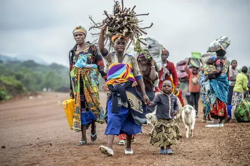 Residents flee fighting between M23 rebels and Congolese forces near Kibumba, some 20 kms ( 12 miles) North of Goma, Democratic republic of Congo, on Oct. 29, 2022. The accounts are haunting. Abductions, torture, rapes. Scores of civilians including women and children have been killed by the M23 rebels in eastern Congo, according to a U.N. report expected to be published this week. (AP Photo/Moses Sawasawa, File)