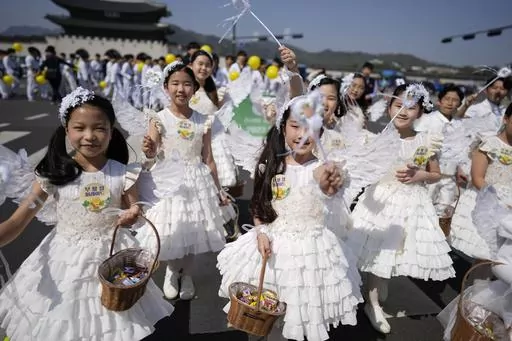 Children dressed as angels march during an Easter parade in Seoul, South Korea, on April 9, 2023. A new law that went into effect Wednesday, June 28, formalizes the international age-counting method as standard in administrative and civil laws and encourages people to tally their own ages accordingly. The country's previous age-counting method made people a year or two older than they really are. (AP Photo/Lee Jin-man, File)