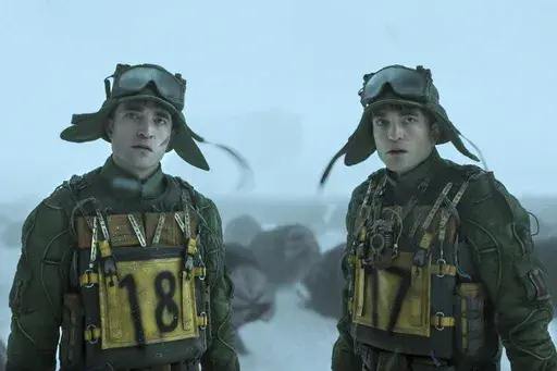 This image released by Warner Bros. Pictures shows Robert Pattinson as Mickey 18, left, and Mickey 17 in a scene from "Mickey 17." (Warner Bros. Pictures via AP)