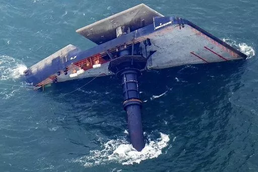 The capsized lift boat Seacor Power is seen seven miles off the coast of Louisiana in the Gulf of Mexico, April 18, 2021. An outage involving a Coast Guard marine warning system and “data gaps” in existing radar systems were contributing factors in last year’s deadly capsizing of an oil industry offshore “lift boat” off of Louisiana’s coast, the National Transportation Safety Board said in a report issued Tuesday, Oct. 18, 2022. (AP Photo/Gerald Herbert, File)