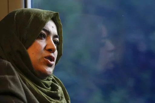 Batool Haidari, 37, talks during an interview with the Associated Press on a train taking her from her home on the outskirts of Rome, to the capital's center, Monday, Dec. 5, 2022. Batool Haidari was a prominent professor of sexology at a university in Kabul before last year’s Taliban takeover of Afghanistan. She used to lecture mixed classes of male and female students and look after her patients struggling with their gender identity. That comfortable life came to an abrupt halt on Aug. 15, 2