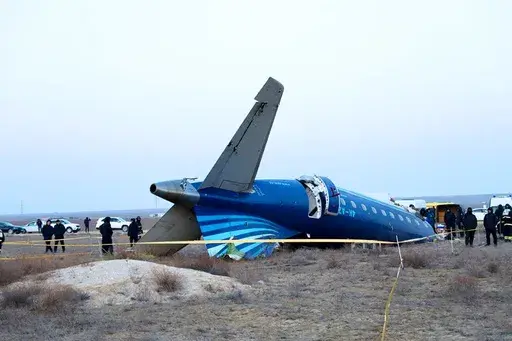 In this photo taken from a video released by the administration of Mangystau region, a part of Azerbaijan Airlines' Embraer 190 lies on the ground near the airport of Aktau, Kazakhstan, on Thursday, Dec. 26, 2024. (The Administration of Mangystau Region via AP)
