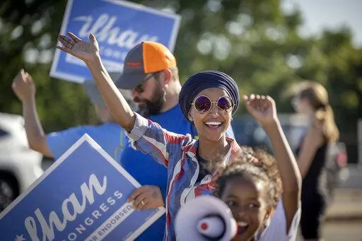 U.S. Rep. Ilhan Omar waves to passersby for support during a voter engagement event on the corner of Broadway and Central Avenues in Minneapolis, on Tuesday, Aug. 9, 2022. Omar faces a primary challenge from former city council member Don Samuels. (Elizabeth Flores/Star Tribune via AP)