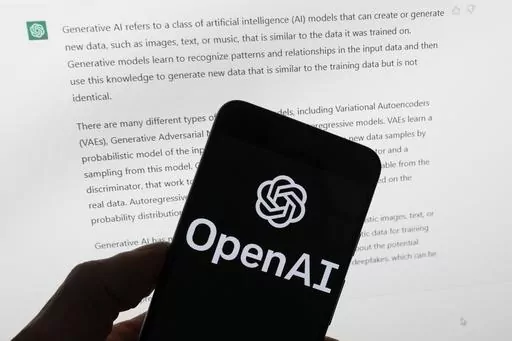The OpenAI logo is seen on a mobile phone in front of a computer screen displaying output from ChatGPT, on March 21, 2023, in Boston. Italian regulators said they informed OpenAI that its ChatGPT artificial intelligence chatbot has violated European Union’s stringent data privacy rules. The country’s data protection authority, known as Garante, said Monday, Jan. 29, 2024, that it notified San Francisco-based OpenAI of breaches of the EU rules, known as General Data Protection Regulation. (AP