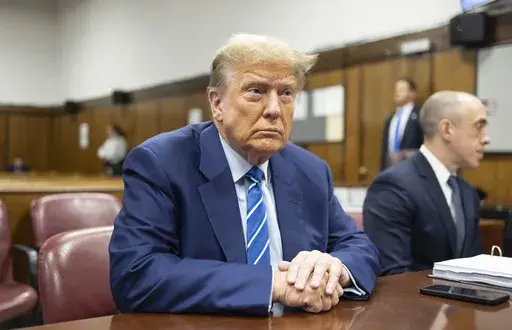 Former President Donald Trump awaits the start of proceedings on the second day of jury selection at Manhattan criminal court, April 16, 2024, in New York. Manhattan prosecutors are balking at Donald Trump efforts to delay post-trial decisions in his New York hush money criminal case as he seeks to have a federal court intervene and potentially overturn his felony conviction. They lodged their objections in a letter Tuesday to the trial judge but said they could be OK with postponing the ex-pres