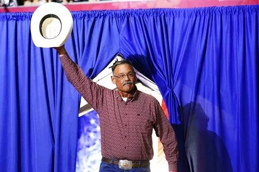 Mark Finchem, a Republican candidate for Arizona Secretary of State, waves to the crowd as he arrives to speak at a Save America rally Friday, July 22, 2022, in Prescott, Ariz. (AP Photo/Ross D. Franklin)