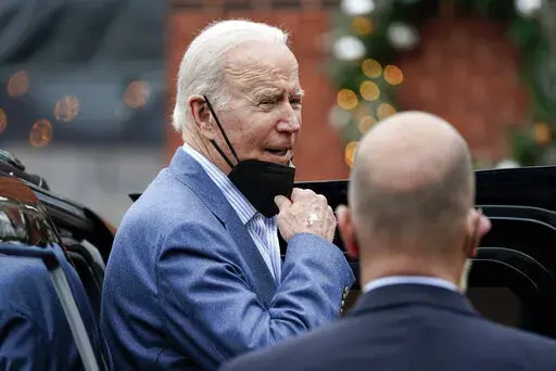 President Joe Biden speaks to members of the media as gets into his motorcade after having New Year's Eve lunch with first lady Jill Biden at Banks' Seafood Kitchen in Wilmington, Del., Friday, Dec. 31, 2021. (AP Photo/Carolyn Kaster)