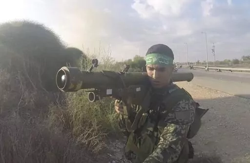 In this image from body camera video during the Oct. 7, 2023, surprise attack on Israel, a Hamas fighter holds a Russian-designed 9M32 Strela anti-aircraft missile. An Associated Press analysis of more than 150 videos and photos taken in the three months of combat since Hamas launched its Oct. 7 surprise attack on Israel shows the militant group has amassed a diverse patchwork arsenal of weapons from around the world – much of it smuggled past a 17-year blockade that was aimed at stopping just