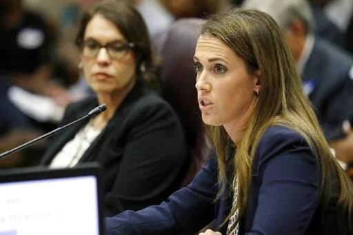 Paula Vanderford, chief accountability officer for the Mississippi Department of Education, left, listens to Erin Meyer, a special attorney general assigned to the department, presents a summary on why the state should initiate a takeover process of the Jackson Public Schools to members of the Commission on School Accreditation in Jackson, Miss., Wednesday, Sept. 13, 2017. On Thursday, July 21, 2022, the Mississippi Board of Education voted to update a 1990 internal policy that prohibited anyone