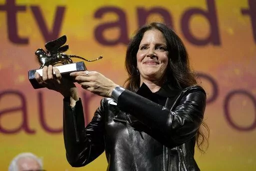 Director Laura Poitras holds the Golden Lion award for best film for 'All the Beauty and the Bloodshed' at the closing ceremony of the 79th edition of the Venice Film Festival in Venice, Italy, Saturday, Sept. 10, 2022. (AP Photo/Domenico Stinellis)