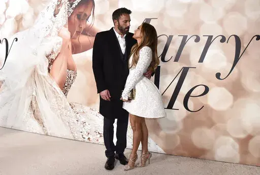 Cast member Jennifer Lopez, right, and Ben Affleck attend a photo call for a special screening of "Marry Me" at DGA Theater on Feb. 8, 2022, in Los Angeles. Lopez and Affleck said “I do” again this weekend. But instead of in a late night Las Vegas drive through chapel, this time it was in front of friends and family in Georgia, a person close to the couple who was not authorized to speak publicly said Sunday, Aug. 21, 2022. (Photo by Jordan Strauss/Invision/AP, File)