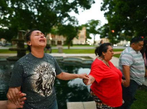 Kladys Castellón prays during a vigil for the victims of a mass shooting at Robb Elementary School in Uvalde, Texas, on Tuesday, May 24, 2022. (Billy Calzada/The San Antonio Express-News via AP)