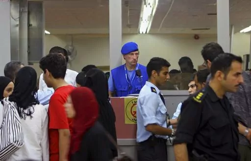A European Union observer watches Palestinians pass from Egypt into the Gaza Strip at the Rafah border Tuesday, July 18, 2006. The European Union withdrew the monitoring mission formed to promote a two-state solution between Israel and the Palestinians from Gaza after the Hamas militant group seized power in 2007. But 16 years later, the mission continues to maintain offices in Israel in hopes of one day returning. Critics say the ongoing Western commitment to the two-state solution fails to rec