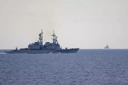 In this photo released by the Taiwan Ministry of National Defense, Taiwan guided missile destroyer Ma Kong DDG1805, left, monitors Chinese guided missile destroyer Xi'an DDG15, right, near Taiwan on Thursday, May 23, 2024. Taiwan tracked dozens of Chinese warplanes and navy vessels off its coast Friday on the second day of a large exercise China's People's Liberation Army held in response to the inauguration of the island's new leadership. (Taiwan Ministry of National Defense via AP)
