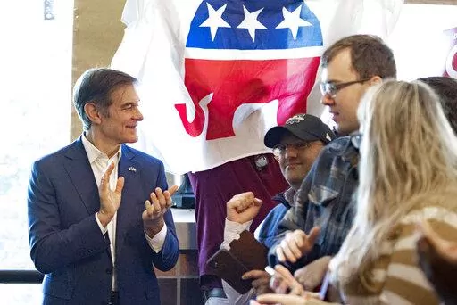 Supporters gather to hear Mehmet Oz, left, a Republican candidate for U.S. Senate in Pennsylvania, speak during a campaign event in Malvern, Pa., Saturday, Oct. 15, 2022. (AP Photo/Laurence Kesterson, File)