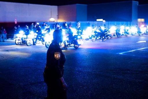 Officers and community members gathered at the beginning of a "Sea of Blue" in honor of fallen officer Geoffrey Redd that directly followed a visitation at Greater Community Temple on Monday, Feb. 27, 2023 in Memphis, Tenn. Redd was shot while responding to a confrontation at a library was remembered at his funeral Tuesday as a strong, proud and dedicated U.S. Marine and public servant. (Brad Vest/Daily Memphian via AP)