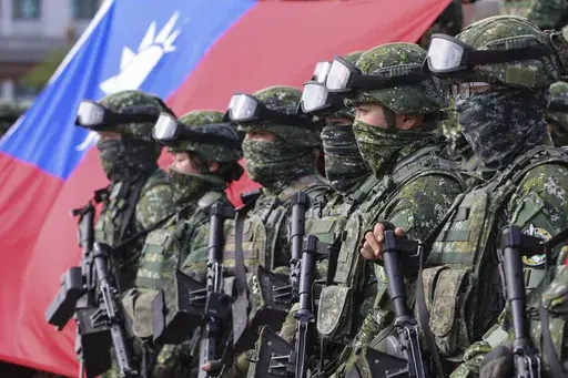 Soldiers pose for group photos with a Taiwan flag after a preparedness enhancement drill simulating the defense against Beijing's military intrusions, ahead of the Lunar New Year in Kaohsiung City, Taiwan on Jan. 11, 2023. Taiwan says 103 Chinese warplanes flew toward the island in new daily high in recent times. Taiwan's Defense Ministry said that it detected the planes in the 24 hours ending at 6 a.m. Monday, Sept. 18, 2023. (AP Photo/Daniel Ceng, File)