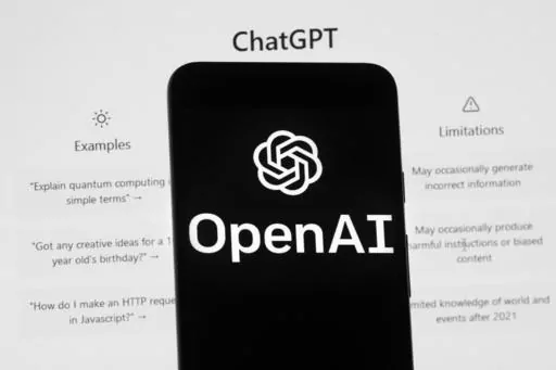The OpenAI logo is seen on a mobile phone in front of a computer screen which displays the ChatGPT home Screen, on March 17, 2023, in Boston. ChatGPT's maker said Friday April 28, 2023 that the artificial intelligence chatbot is available again in Italy after the company met the demands of regulators who temporarily blocked it over privacy concerns. (AP Photo/Michael Dwyer, File)