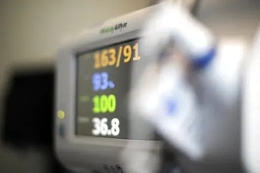 In this Aug. 8, 2020, photo a patient's vital signs are displayed on a monitor at a hospital in Portland, Ore. At its current pace, Medicare’s Hospital Insurance trust fund will run out of money in 2028, according to the latest Medicare trustees report. That’s a two-year extension on the previous estimate. (AP Photo/Jenny Kane, File)