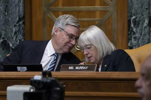 Senate Budget Committee Chairman Sheldon Whitehouse, D-R.I., confers with Sen. Patty Murray, D-Wash., right, during a hearing on the Republican proposal to address the debt limit which passed along party lines in the House last week, at the Capitol in Washington, Thursday, May 4, 2023. Senate Democrats are looking to pressure Republicans into resolving the impasse on the debt ceiling. (AP Photo/J. Scott Applewhite)