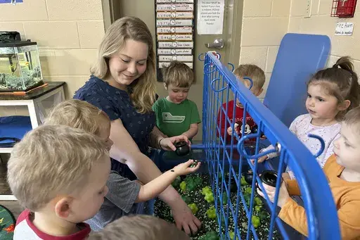 Rylee Monn plays with children in her class at a child care center in Lexington, Ky., March 13, 2024. (AP Photo/Dylan Lovan, File)