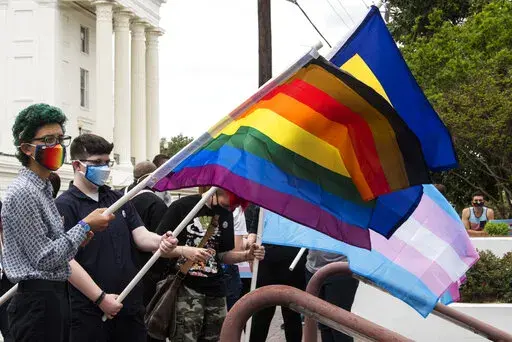 Protestors in support of transgender rights rally outside the Alabama State House in Montgomery, Ala., on Tuesday, March 30, 2021. The Alabama Senate on Wednesday, Feb. 23, 2022, approved legislation that would prohibit transgender minors from being given puberty-blockers, hormones or surgeries to affirm their gender identity - treatments that the legislative sponsor equated to child abuse. (Jake Crandall/The Montgomery Advertiser via AP, File)