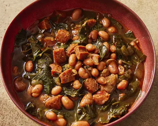 This image released by Milk Street shows a recipe for paprika-pinto bean soup with collard greens. (Milk Street via AP)