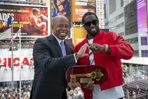 This photo provided by the Office of the New York Mayor, shows Mayor Eric Adams, left, presenting the Key to the City to hip-hop artist Sean "Diddy" Combs in New York's Times Square, Friday, Sept. 15, 2023. Combs has returned his key to New York City after a request from Adams in response to the release of a video showing the music mogul attacking R&B singer Cassie, officials said Saturday. (Office of the New York Mayor/Caroline Rubinstein-Willis via AP)