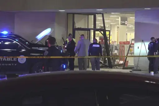 This image taken from video provided by KCEN-TV shows police responding after a man drove a vehicle into a JCPenney at a shopping mall Saturday, Dec. 21, 2024, in Killeen, Texas. (KCEN-TV via AP)