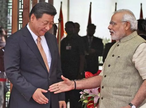 FILE- Indian Prime Minister Narendra Modi welcomes Chinese President Xi Jinping upon the latter's arrival at a hotel in Ahmadabad, India, Wednesday, Sept. 17, 2014. India is protesting a new Chinese map that lays claim to India’s territory ahead of next week's Group of 20 summit in New Delhi, a foreign ministry official said on Tuesday, Aug. 29, 2023, exacerbating tensions during a three-year military standoff between the two nations. The timing of the protest is key, as Chinese President Xi J