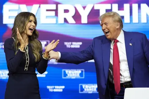 Republican presidential nominee former President Donald Trump stands with South Dakota Gov. Kristi Noem during a campaign town hall at the Greater Philadelphia Expo Center & Fairgrounds, Oct. 14, 2024, in Oaks, Pa. (AP Photo/Alex Brandon, File)